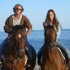 Tommy and Rita on horses with ocean in background